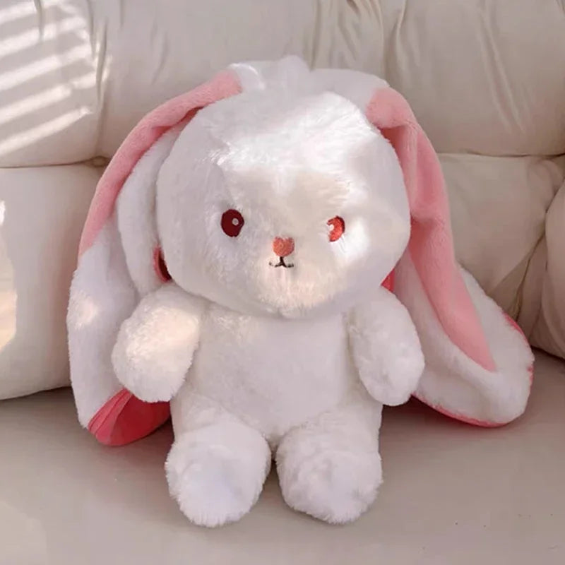 Soft white bunny plush with pink ears and red eyes.