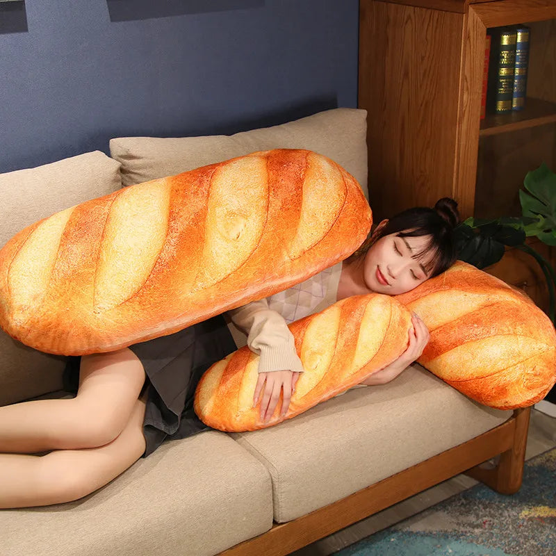 Person lying on a sofa using an oversized baguette pillow as a body cushion for comfort and naps.