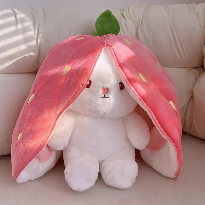 White bunny plush in pink strawberry hood.
