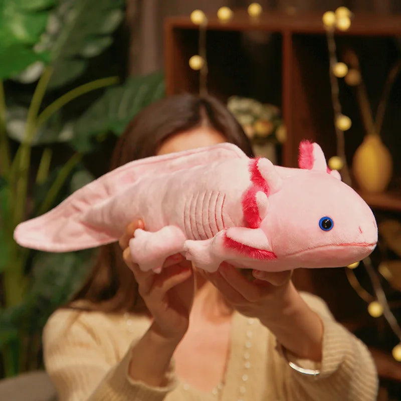 Large pink axolotl plush toy held up for display, highlighting its long body and soft stuffed design.