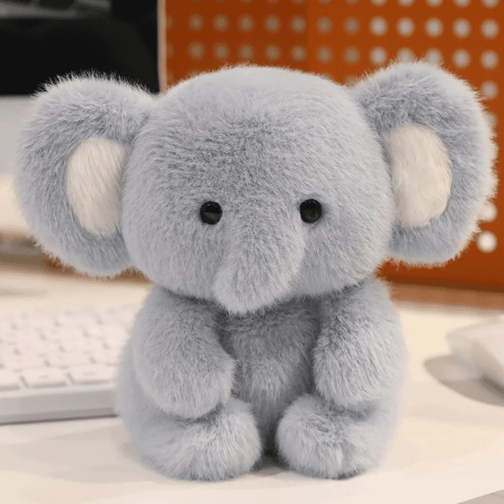 Little Cuddle Buddies mini blue otter with white ears plush toy on computer desk