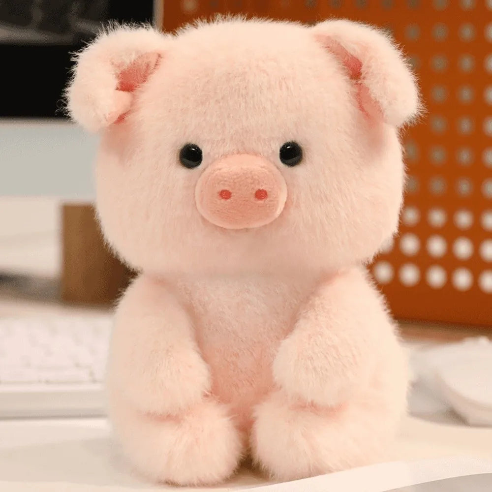 Little Cuddle Buddies mini pink piggy plush toy on computer desk.  