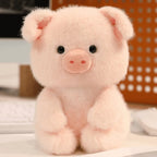Little Cuddle Buddies mini pink piggy plush toy on computer desk.  
