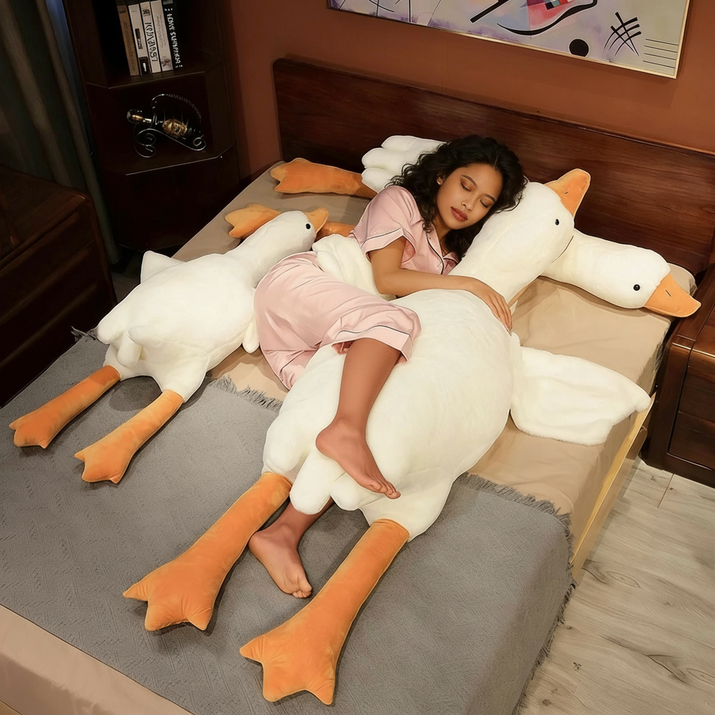 Smiling woman in pink dress hugging giant white goose plush toy on cozy bed for Sleepy Buddies
